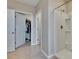 Tiled bathroom showcasing a walk-in shower and walk-in closet space at 623 Grove St, Winter Haven, FL 33881