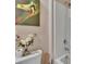 Bright bathroom featuring a tiled shower and unique artwork at 623 Grove St, Winter Haven, FL 33881
