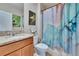 Well-maintained bathroom with a modern vanity, decorative wall art, and a stylish shower curtain at 623 Grove St, Winter Haven, FL 33881