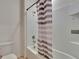 Bathroom featuring a white shower/tub combo with gray and white shower curtain at 623 Grove St, Winter Haven, FL 33881
