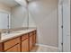Bathroom featuring double sinks, granite countertops, and wood cabinets at 623 Grove St, Winter Haven, FL 33881