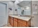 Bright bathroom featuring double sinks, granite countertops and a large mirror at 623 Grove St, Winter Haven, FL 33881