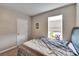 Bedroom features neutral walls, carpet flooring, and window with blinds at 623 Grove St, Winter Haven, FL 33881