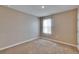 Bright bedroom featuring neutral carpet flooring, neutral colored walls, and natural light at 623 Grove St, Winter Haven, FL 33881
