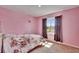 Bedroom featuring pink paint and large window that provides natural light at 623 Grove St, Winter Haven, FL 33881