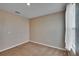 Simple bedroom with neutral carpet flooring, neutral colored walls, and bright natural light at 623 Grove St, Winter Haven, FL 33881