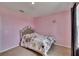 Pink bedroom features carpet, bed, window and curtains at 623 Grove St, Winter Haven, FL 33881