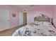 Pink bedroom features carpet, bed, and two doorways at 623 Grove St, Winter Haven, FL 33881
