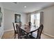 Cozy dining room with a classic table set, complemented by bright natural light streaming through the window at 623 Grove St, Winter Haven, FL 33881