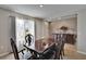 Formal dining room boasts a rich dark wood table, set beneath a bright window, complemented by a decorative sideboard at 623 Grove St, Winter Haven, FL 33881