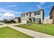 Two-story home boasts well-maintained lawn, driveway, with blue shutters on a bright sunny day at 623 Grove St, Winter Haven, FL 33881