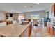 Bright kitchen with large island, granite counters, stainless steel appliances, open to dining area with backyard views at 623 Grove St, Winter Haven, FL 33881