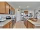 Well-lit kitchen with stainless steel appliances, granite countertops, and wood cabinets at 623 Grove St, Winter Haven, FL 33881