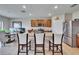 Open concept kitchen with granite countertops, stainless steel appliances, a breakfast bar with seating, and tile flooring at 623 Grove St, Winter Haven, FL 33881