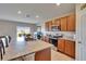 Kitchen island features granite countertops and bar seating, next to stainless steel appliances and ample cabinet space at 623 Grove St, Winter Haven, FL 33881