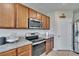 Kitchen with granite countertops, stainless steel appliances, range, tile flooring, and ample wooden cabinets at 623 Grove St, Winter Haven, FL 33881