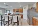 Spacious kitchen featuring granite countertops, stainless steel refrigerator, eat-in bar with chairs, and tile flooring at 623 Grove St, Winter Haven, FL 33881