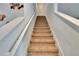 Carpeted staircase with white handrails leading to upper level at 623 Grove St, Winter Haven, FL 33881
