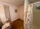 Bathroom featuring a shower, toilet, and a floral shower curtain at 7175 Se 123Rd Pl, Belleview, FL 34420