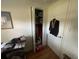 A closet in a bedroom with clothes and an opened door to see the room in the house at 7175 Se 123Rd Pl, Belleview, FL 34420
