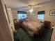 Bedroom with a floral bedspread, a ceiling fan, and natural light from the window at 7175 Se 123Rd Pl, Belleview, FL 34420