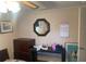 Bedroom featuring a large octagonal mirror, artwork, and a calendar on the wall at 7175 Se 123Rd Pl, Belleview, FL 34420