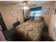 Cozy bedroom featuring a floral bedspread and ceiling fan at 7175 Se 123Rd Pl, Belleview, FL 34420