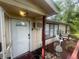 Charming covered entrance area with a decorative porch light and side deck at 7175 Se 123Rd Pl, Belleview, FL 34420