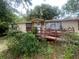 Charming home featuring a covered porch with a ramp nestled amongst trees at 7175 Se 123Rd Pl, Belleview, FL 34420