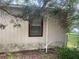 Exterior side view with a window, siding, and overgrown landscaping at 7175 Se 123Rd Pl, Belleview, FL 34420