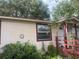 The home features a quaint side with a decorative tile and window at 7175 Se 123Rd Pl, Belleview, FL 34420