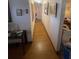 Hallway with wood floors and pictures on the wall at 7175 Se 123Rd Pl, Belleview, FL 34420