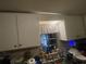 View of a kitchen sink featuring white cabinets and a window at 7175 Se 123Rd Pl, Belleview, FL 34420
