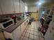Practical kitchen space with white cabinets and a blue trash bin at 7175 Se 123Rd Pl, Belleview, FL 34420