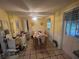 Kitchen with tile floors, a dining table, and yellow walls at 7175 Se 123Rd Pl, Belleview, FL 34420