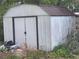Exterior view of a shed with double doors, offering ample storage space at 7175 Se 123Rd Pl, Belleview, FL 34420
