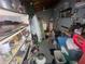 Utility room with shelves and a variety of storage items at 7175 Se 123Rd Pl, Belleview, FL 34420