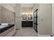 Bathroom featuring a tiled shower, soaking tub, and double vanity with granite countertops at 116 Winding Oaks Ln, Oviedo, FL 32765