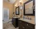 Bathroom featuring a double vanity, tiled floor, and a separate toilet room at 116 Winding Oaks Ln, Oviedo, FL 32765