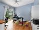 Bright bedroom with hardwood floors, a ceiling fan, and large glass sliding doors to the backyard at 116 Winding Oaks Ln, Oviedo, FL 32765