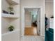 Entryway with decorative shelving and view into the main bedroom at 116 Winding Oaks Ln, Oviedo, FL 32765