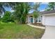 Well maintained single-story home with an attached two-car garage and mature landscaping at 116 Winding Oaks Ln, Oviedo, FL 32765