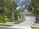 Charming single-story home featuring a two-car garage, manicured lawn, and mature landscaping at 116 Winding Oaks Ln, Oviedo, FL 32765