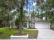 Charming single-story home featuring a two-car garage, manicured lawn, and mature landscaping at 116 Winding Oaks Ln, Oviedo, FL 32765