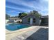Backyard swimming pool with a concrete deck and adjacent building under a sunny sky at 1420 Wood Ave, Haines City, FL 33844
