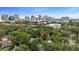 Aerial view of a home in a tree-filled neighborhood with a city skyline in the background at 530 S Eola Dr, Orlando, FL 32801