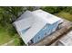 Aerial view of a two-story home featuring a gray shingled roof, light blue siding, and a small upper-level deck at 530 S Eola Dr, Orlando, FL 32801