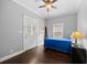 Bedroom with doorway, window, and hardwood floors at 530 S Eola Dr, Orlando, FL 32801