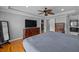 Comfortable bedroom showcases hardwood floors, trey ceiling, fan and a large window at 530 S Eola Dr, Orlando, FL 32801