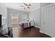 Bedroom with ceiling fan, windows, and hardwood floors at 530 S Eola Dr, Orlando, FL 32801
